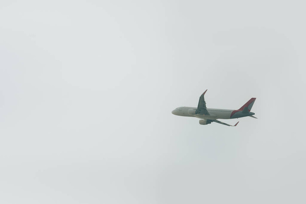 Low angle view of flight departure of plane in cloudy sky  - Fotó, kép