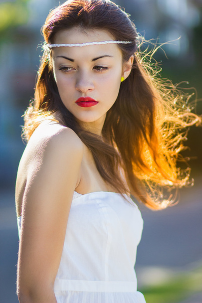 Portrait of a beautiful brunette girl in a short dress with bright makeup - Φωτογραφία, εικόνα