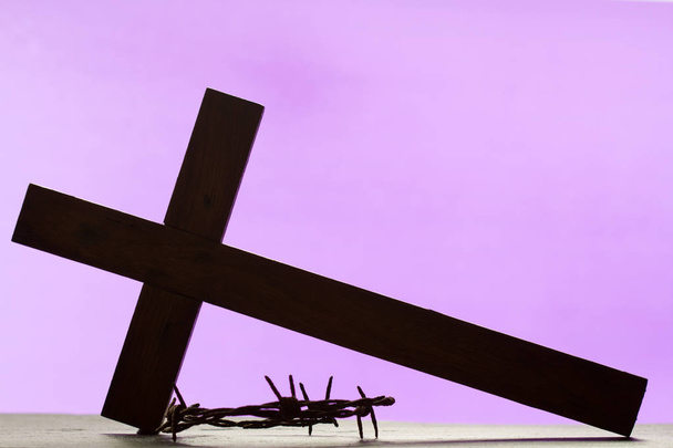 Abstract easter wooden cross and crown of thorns on purple background - Photo, Image