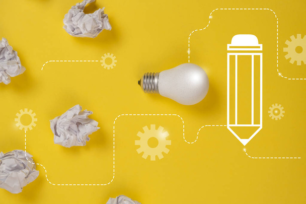 Creativity inspiration, great business idea concept with white light bulb and paper crumpled ball on yellow background. Flat lay, top view, copy space - Zdjęcie, obraz