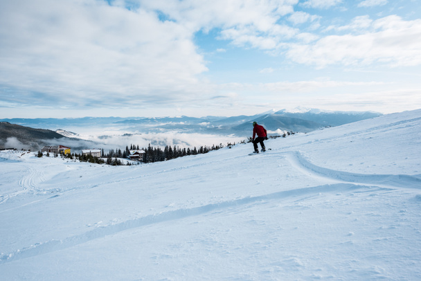 snowboarder riding on slope with white snow in wintertime  - Photo, Image