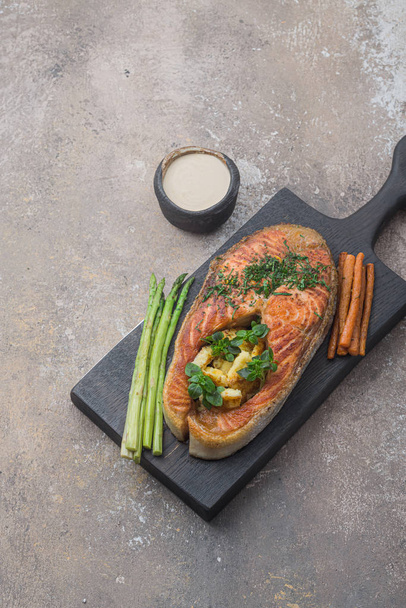 Fried salmon steak with polenta on wooden board, copy space - Photo, Image