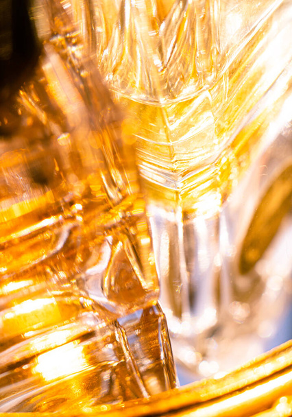 Beautiful bokeh and light reflections in yellow glass perfume bottles - Φωτογραφία, εικόνα