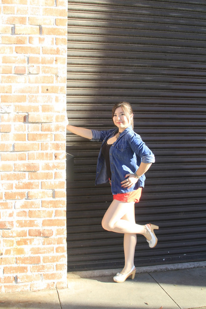 Asian model posing in front of garage door. - Foto, Imagen