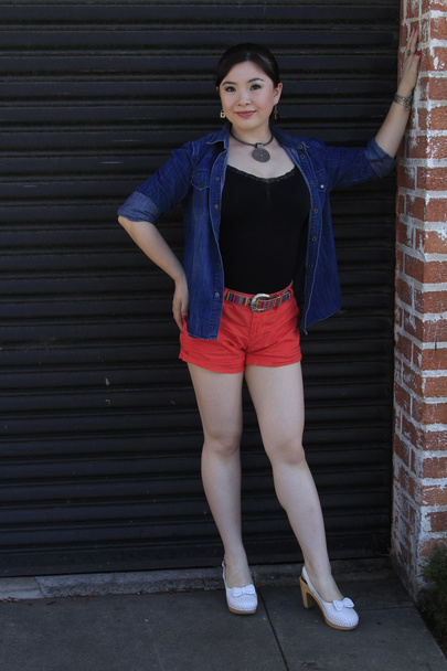 Asian model posing in front of garage door. - Valokuva, kuva