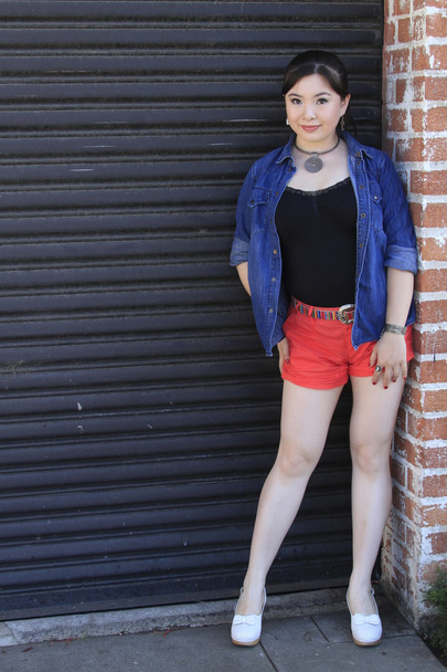 Asian model posing in front of garage door. - Fotó, kép