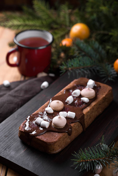 cake with chocolate icing and marshmallows. Christmas and New Year. wood background - Foto, Imagen