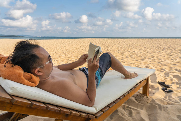 Man relax with a good book in beautiful beach - Photo, Image
