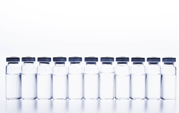 Glass medicine vials on a white background - Valokuva, kuva
