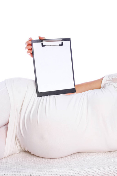 Happy pregnant girl lies on white background - Photo, Image