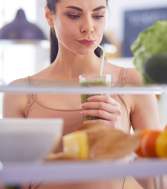 Young woman with glass of tasty healthy smoothie at table in kitchen - Φωτογραφία, εικόνα
