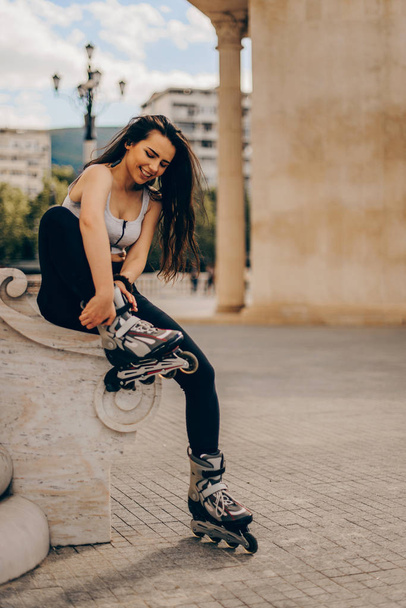 Amazing girl is getting ready for roller skating - Photo, Image