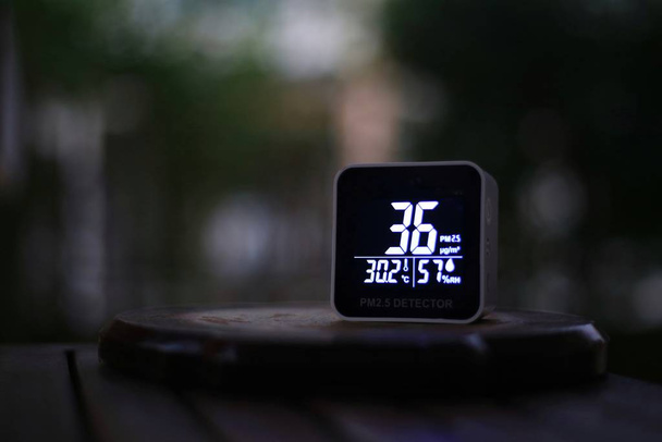 PM 2.5 (particulate matter), small harmful dust sensor detects slightly particles level over safety threshold. bad air quality, urban environmental and health standard problem. - Photo, Image