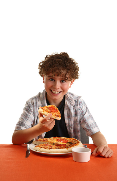 Boy eating pizza - Фото, изображение