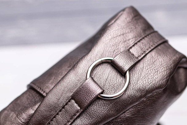 Fashion synthetic leather bronze handbag on a wooden background. Eco leather. - Photo, Image