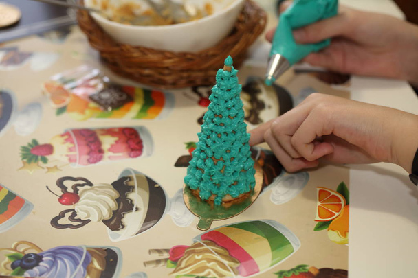 Children's hands with a filling for Christmas baking - Fotó, kép