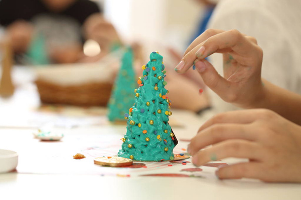 Children's hands with a filling for Christmas baking - Fotografie, Obrázek
