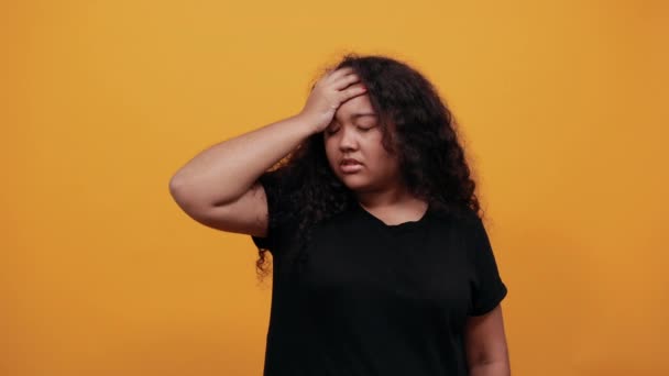 Disappointed young woman with overweight keeping hand on head, headache, tired - Filmmaterial, Video