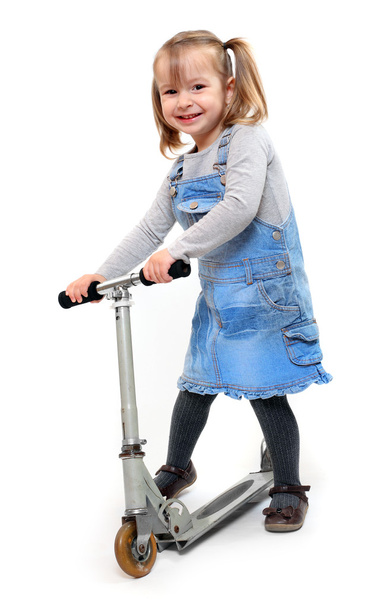 Little girl riding her children scooter. - Fotografie, Obrázek
