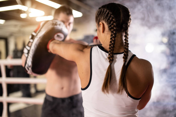 young caucasian couple train to box in ring - Фото, зображення