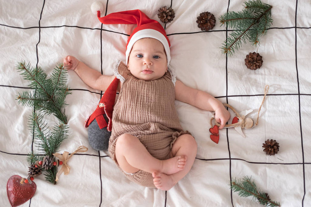 little cute baby girl portreit in red christmas santa hat with lights top view. Christmas holidays  - Φωτογραφία, εικόνα