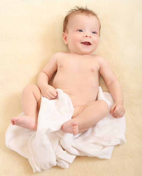 Happy baby in diaper lying on the bed. - Photo, Image