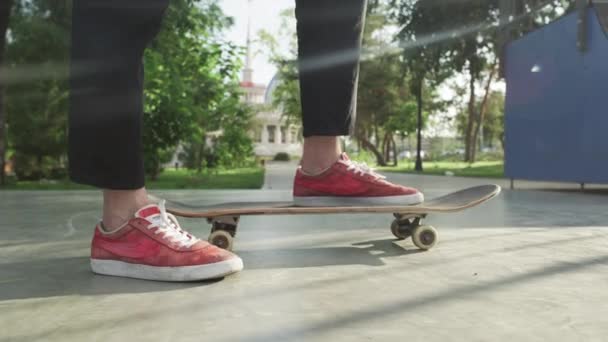Skateboarder standing with skateboard in skatepark - 映像、動画