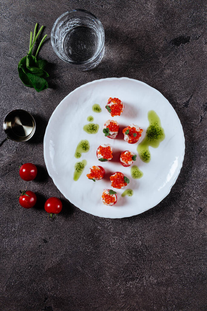 Three stuffed tomatoes on a white plate - Photo, Image