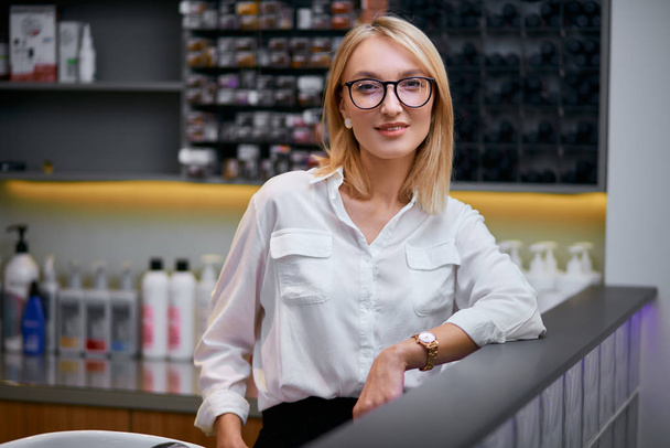 young and beautiful caucasian woman seller or consultant in beauty saloon - Φωτογραφία, εικόνα
