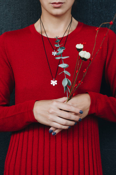 Woman in red dress wearing silver pendants - Foto, Imagem