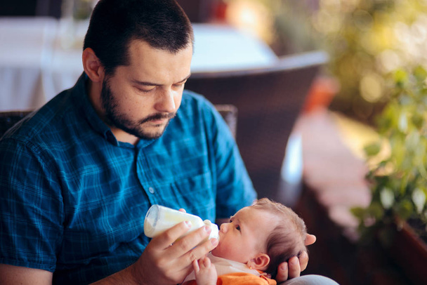 Father Feeding Newborn Baby in a Restaurant - Foto, afbeelding