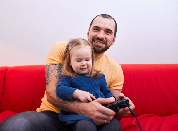 sweet little daughter sit with dad in playing center - Foto, Imagem
