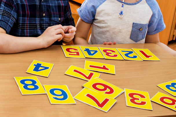 Kids are playing. Educational games. A child in kindergarten. Hands of a child. Math tablets. - 写真・画像