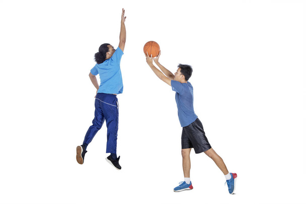 Two athletic men playing basketball together - Фото, зображення