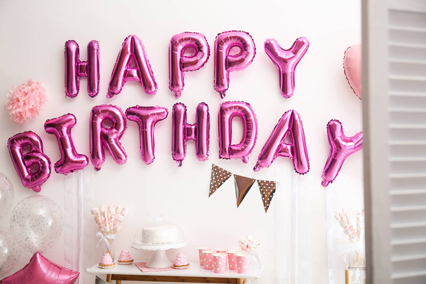 Phrase HAPPY BIRTHDAY made of pink balloon letters in decorated room - Zdjęcie, obraz