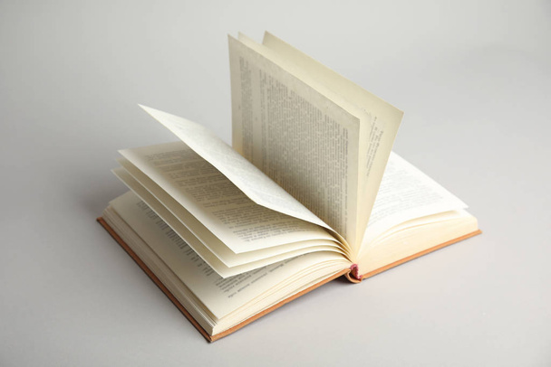 Open old hardcover book on light grey background - Foto, imagen