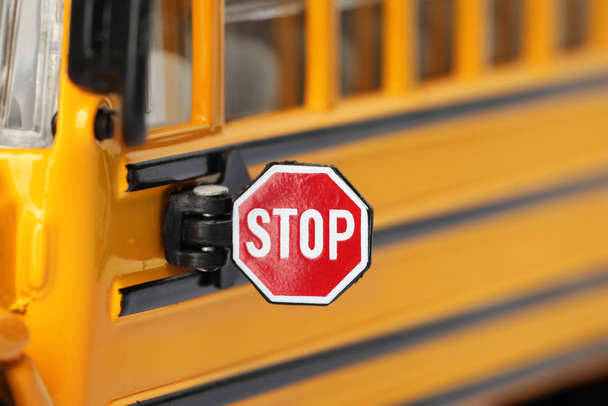 Yellow school bus, focus on stop sign. Transport for students - Zdjęcie, obraz