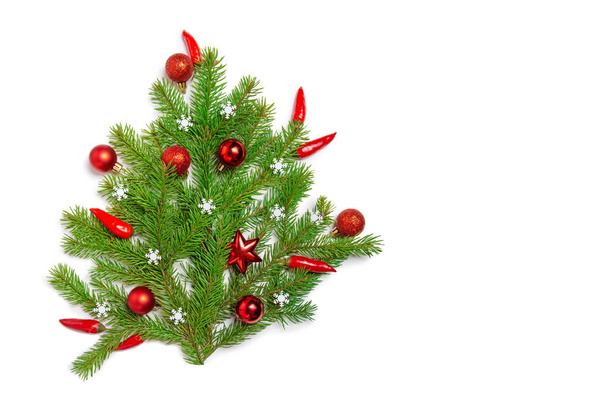 Christmas flatly copyspace. Red Christmas ornament, spicy pepper and sprigs of spruce on a white isolated background. Design elements.  - Fotoğraf, Görsel