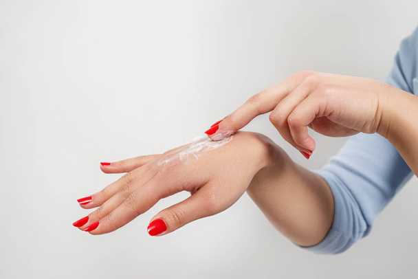 woman applying cream on hands - Foto, Imagen
