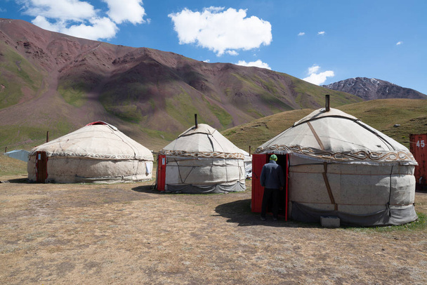 Kyrgyzstan, Pamir, circa august 2019: Yurts in the village on the road trip from Osh Kyrgyzstan to Tajikistan through the Pamir highway - Photo, image