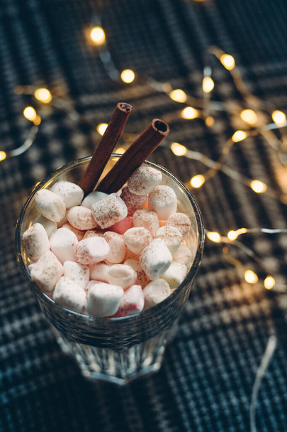 Hot chocolate with marshmallows and cinnamon stick. Christmas and new year background. Top view - Photo, Image