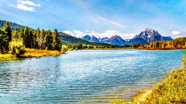 Mount Moran and surrounding Mountains in the Teton Mountain Range of Grand Teton National Park with Kayakers on the Snake River. Viewed from Oxbow Bend of the Snake River in Wyoming, United Sates - Photo, Image