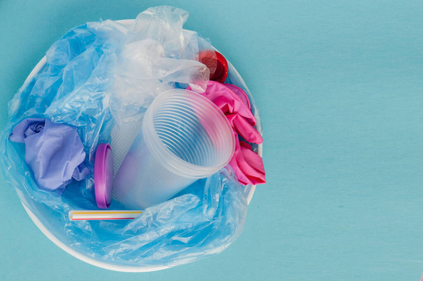 Top view of various kinds of disposable plastic waste on blue ba - 写真・画像