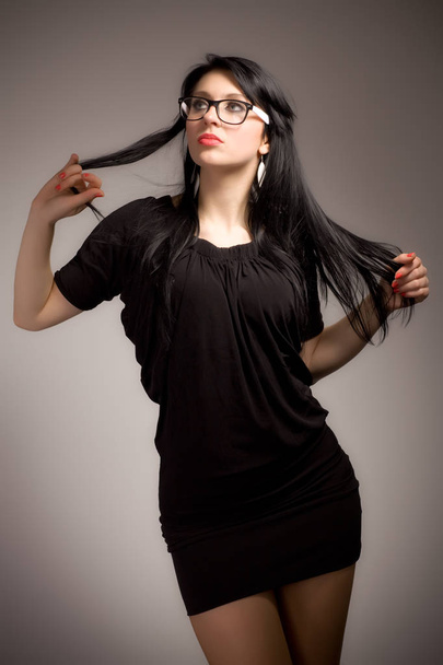 Young brunette woman in black clothing and glasses - Foto, Bild