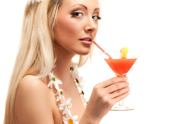Blond woman in costume made from chamomile flowers holding cocktail in glass - Foto, immagini