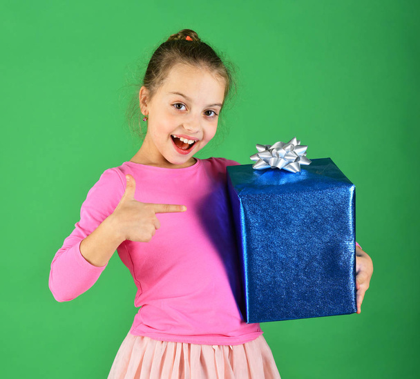 Birthday surprise concept. Lady points at blue gift for Christmas - Foto, afbeelding