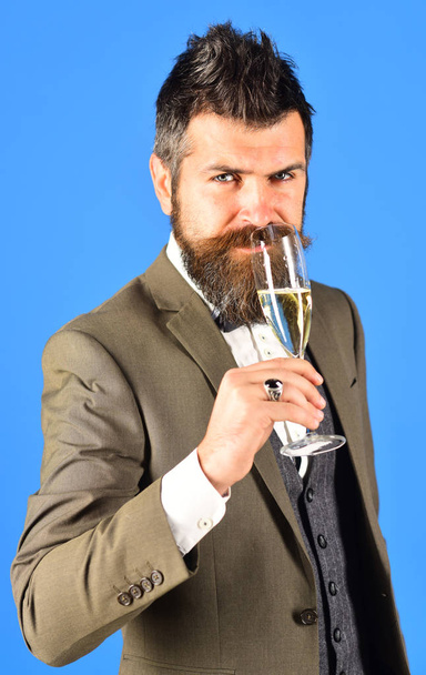 Businessman with happy confident face holds sparkling wine. - 写真・画像