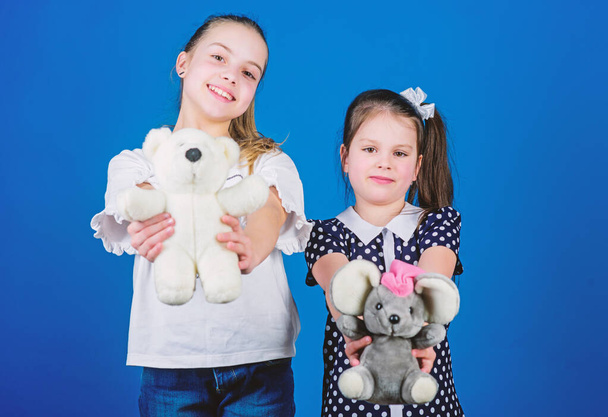 kindergarten concept. small girls with soft bear toys. happy little sisters girls playing game in playroom. handmade. sewing and diy crafts. playground in kindergarten. toy shop. childrens day - Photo, Image