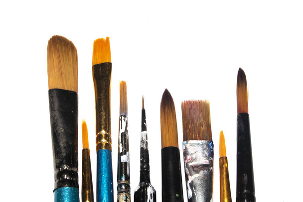 Messy Used Paint Brushes on White background - 写真・画像