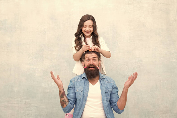 Change hairstyle. With healthy dose of openness any dad can excel at raising girl. Create funny hairstyle. Child making hairstyle styling father beard. Being parent means present for kid interests - 写真・画像